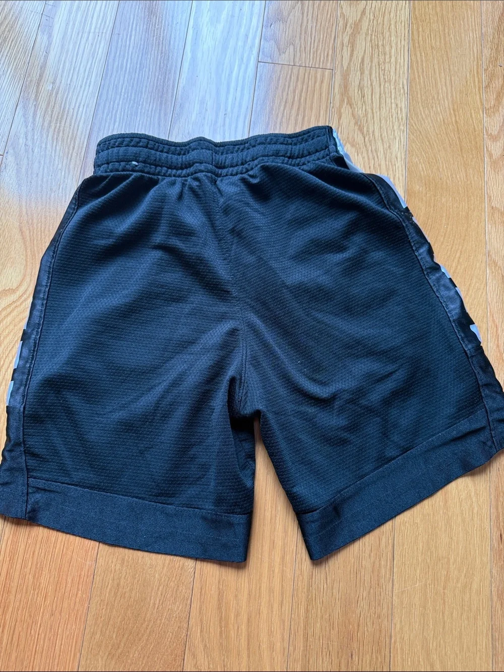 Nike Black Shorts with White Swoosh and Side Stripes